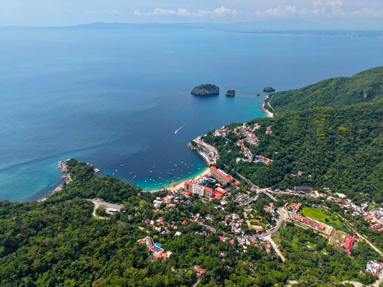 Fishing boats at Mismaloya Beach with Los Arcos offshore